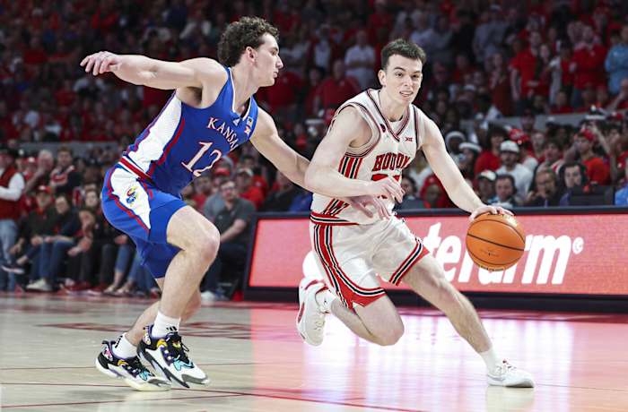 Mar 9, 2024; Houston, Texas, USA; Houston Cougars guard Ryan Elvin (20) controls the ball as Kansas Jayhawks guard Wilder Evers (12) defends during the second half at Fertitta Center. 